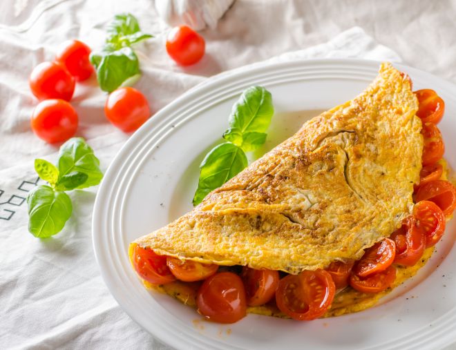 Rustic omelet with tomato, simple photo on white napkin